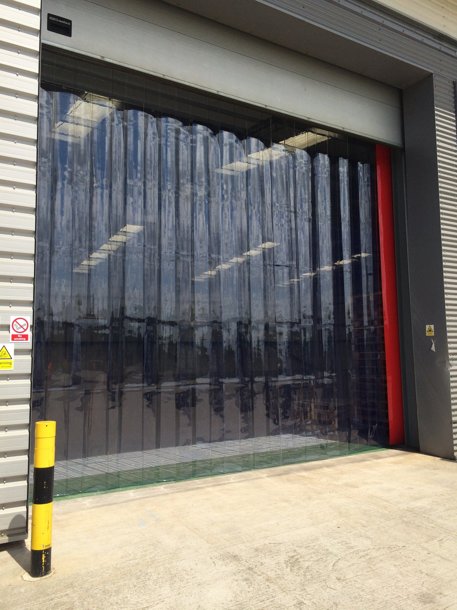 External PVC strip curtain fitted at Alchemy Logistics warehouse entrance to improve airflow, energy efficiency, and hygiene.
